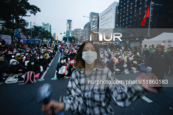 A student who completes the college entrance exam this year dances while participating in a protest calling for the impeachment of President...