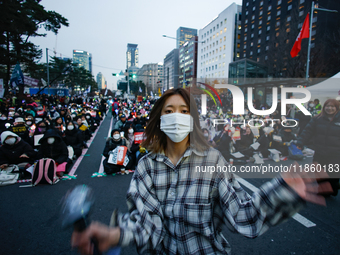 A student who completes the college entrance exam this year dances while participating in a protest calling for the impeachment of President...