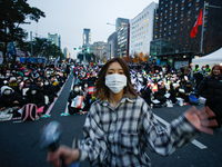 A student who completes the college entrance exam this year dances while participating in a protest calling for the impeachment of President...