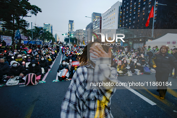 A student who completes the college entrance exam this year dances while participating in a protest calling for the impeachment of President...