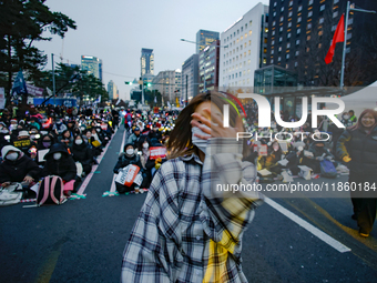 A student who completes the college entrance exam this year dances while participating in a protest calling for the impeachment of President...