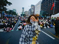 A student who completes the college entrance exam this year dances while participating in a protest calling for the impeachment of President...