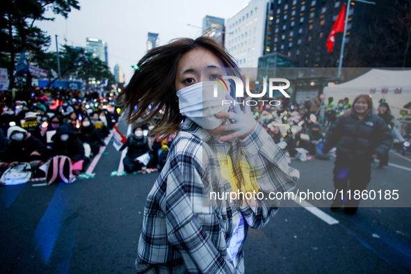 A student who completes the college entrance exam this year dances while participating in a protest calling for the impeachment of President...