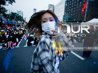 A student who completes the college entrance exam this year dances while participating in a protest calling for the impeachment of President...