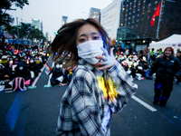 A student who completes the college entrance exam this year dances while participating in a protest calling for the impeachment of President...