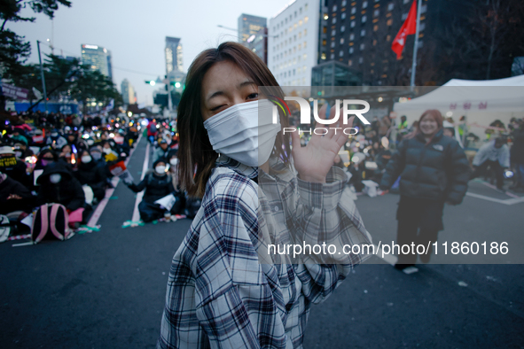 A student who completes the college entrance exam this year dances while participating in a protest calling for the impeachment of President...