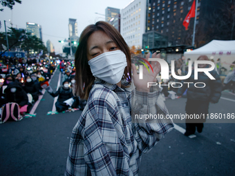 A student who completes the college entrance exam this year dances while participating in a protest calling for the impeachment of President...