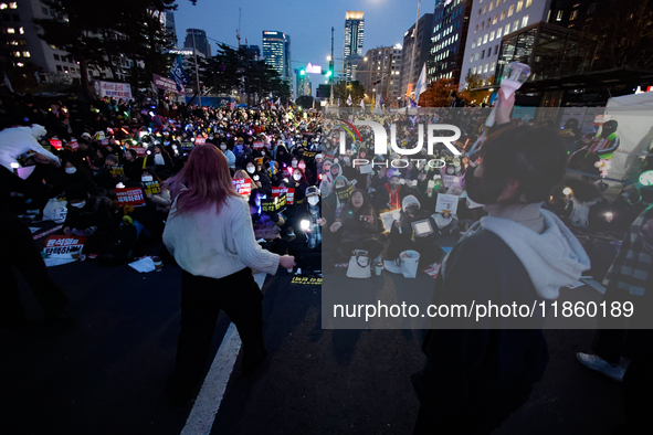 Participants dance while participating in a protest calling for the impeachment of President Yoon Suk Yeol in Yeouido, Seoul, South Korea, o...