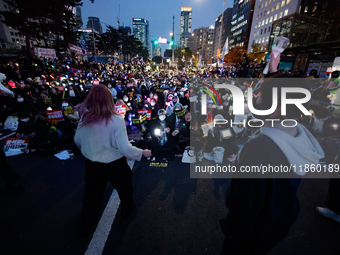 Participants dance while participating in a protest calling for the impeachment of President Yoon Suk Yeol in Yeouido, Seoul, South Korea, o...