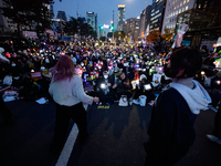 Participants dance while participating in a protest calling for the impeachment of President Yoon Suk Yeol in Yeouido, Seoul, South Korea, o...