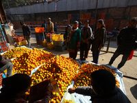 People purchase oranges from a local market in Kathmandu, Nepal, on December 12, 2024. Nepali fruit markets are flooded with oranges as the...