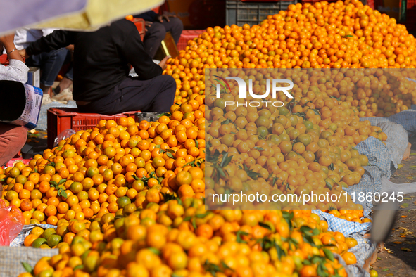 A pile of oranges is pictured at a marketplace in Kathmandu, Nepal, on December 12, 2024. Nepali fruit markets are flooded with oranges as t...