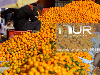 A pile of oranges is pictured at a marketplace in Kathmandu, Nepal, on December 12, 2024. Nepali fruit markets are flooded with oranges as t...