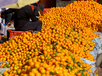 A pile of oranges is pictured at a marketplace in Kathmandu, Nepal, on December 12, 2024. Nepali fruit markets are flooded with oranges as t...