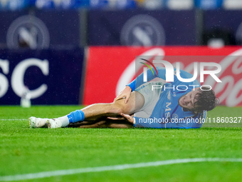 Khvicha Kvaratskhelia of SSC Napoli lies down injured during the serie Serie A Enilive match between SSC Napoli and SS Lazio at Stadio Diego...