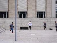 A group of four boys plays soccer on a forecourt of a modern building in Lido, Venice Lagoon, Italy, on November 13, 2021. (