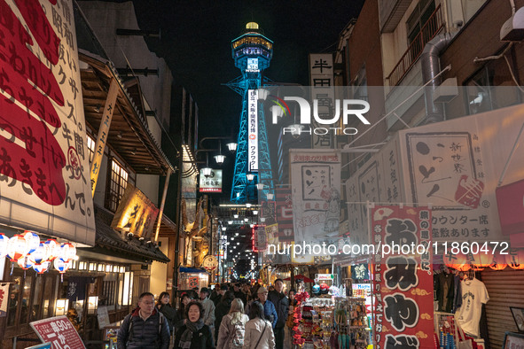 The street is full of tourists in Shinsekai, where Tsutenkaku Tower is within sight in Osaka, Japan, on December 12, 2024. Shinsekai, which...