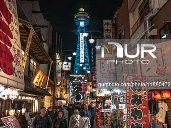 The street is full of tourists in Shinsekai, where Tsutenkaku Tower is within sight in Osaka, Japan, on December 12, 2024. Shinsekai, which...