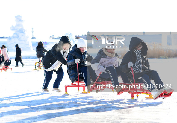 Tourists play at the Manzhouli ''Ice and Snow Nursery Rhyme'' theme park in Hulunbuir, Inner Mongolia, China, on December 12, 2024. 