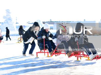 Tourists play at the Manzhouli ''Ice and Snow Nursery Rhyme'' theme park in Hulunbuir, Inner Mongolia, China, on December 12, 2024. (