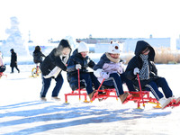 Tourists play at the Manzhouli ''Ice and Snow Nursery Rhyme'' theme park in Hulunbuir, Inner Mongolia, China, on December 12, 2024. (