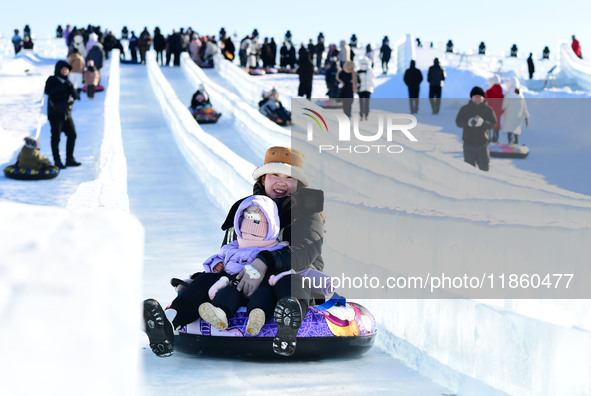 Tourists play at the Manzhouli ''Ice and Snow Nursery Rhyme'' theme park in Hulunbuir, Inner Mongolia, China, on December 12, 2024. 