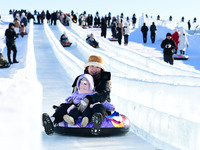 Tourists play at the Manzhouli ''Ice and Snow Nursery Rhyme'' theme park in Hulunbuir, Inner Mongolia, China, on December 12, 2024. (