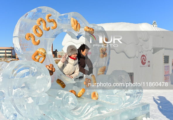 Tourists play at the Manzhouli ''Ice and Snow Nursery Rhyme'' theme park in Hulunbuir, Inner Mongolia, China, on December 12, 2024. 