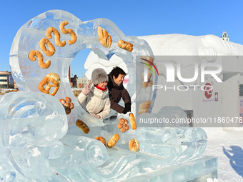 Tourists play at the Manzhouli ''Ice and Snow Nursery Rhyme'' theme park in Hulunbuir, Inner Mongolia, China, on December 12, 2024. (