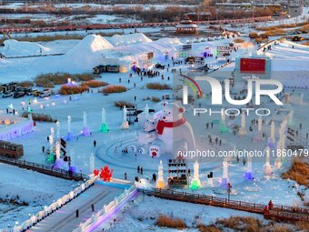 Tourists play at the Manzhouli ''Ice and Snow Nursery Rhyme'' theme park in Hulunbuir, Inner Mongolia, China, on December 12, 2024. (