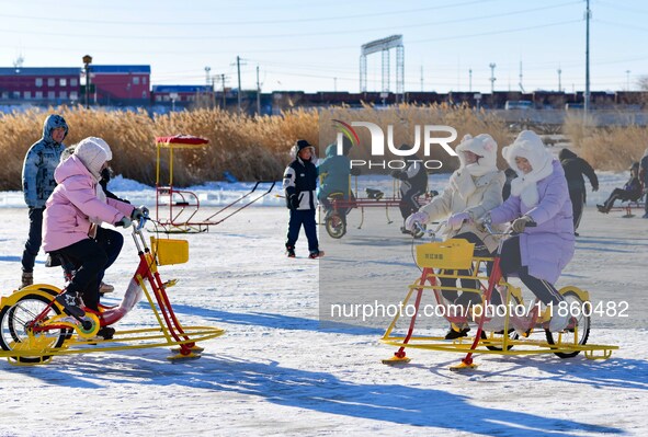 Tourists play at the Manzhouli ''Ice and Snow Nursery Rhyme'' theme park in Hulunbuir, Inner Mongolia, China, on December 12, 2024. 