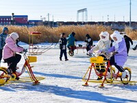 Tourists play at the Manzhouli ''Ice and Snow Nursery Rhyme'' theme park in Hulunbuir, Inner Mongolia, China, on December 12, 2024. (