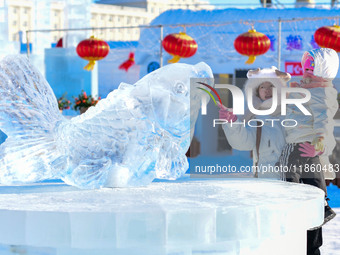 Tourists play at the Manzhouli ''Ice and Snow Nursery Rhyme'' theme park in Hulunbuir, Inner Mongolia, China, on December 12, 2024. (