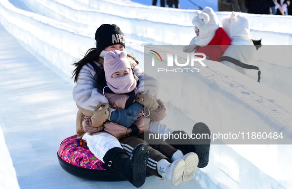 Tourists play at the Manzhouli ''Ice and Snow Nursery Rhyme'' theme park in Hulunbuir, Inner Mongolia, China, on December 12, 2024. 