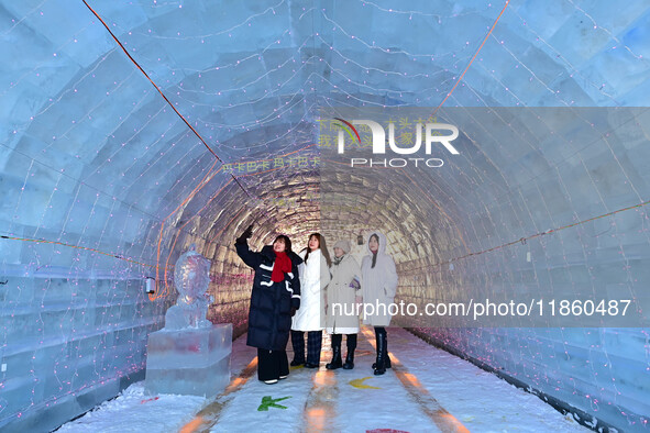 Tourists play at the Manzhouli ''Ice and Snow Nursery Rhyme'' theme park in Hulunbuir, Inner Mongolia, China, on December 12, 2024. 