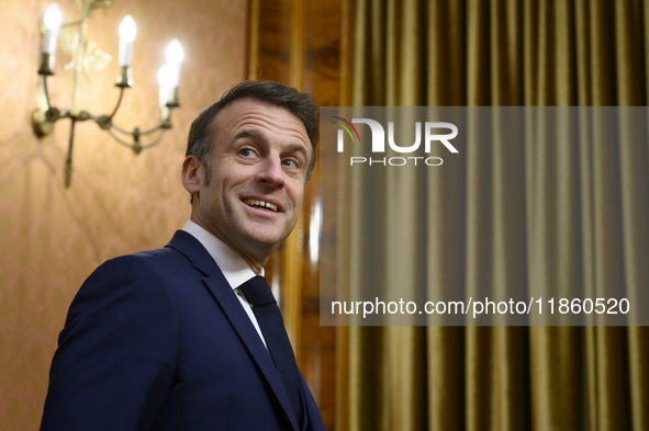 French President Emmanuel Macron smiles as he meets Poland's Prime Minister Donald Tusk in Warsaw, Poland, on December 11, 2024. 