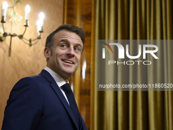 French President Emmanuel Macron smiles as he meets Poland's Prime Minister Donald Tusk in Warsaw, Poland, on December 11, 2024. (