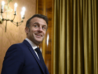 French President Emmanuel Macron smiles as he meets Poland's Prime Minister Donald Tusk in Warsaw, Poland, on December 11, 2024. (