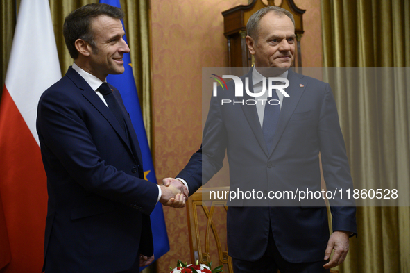 Polish Prime Minister Donald Tusk welcomes French President Emmanuel Macron in Warsaw, Poland, on December 11, 2024. 