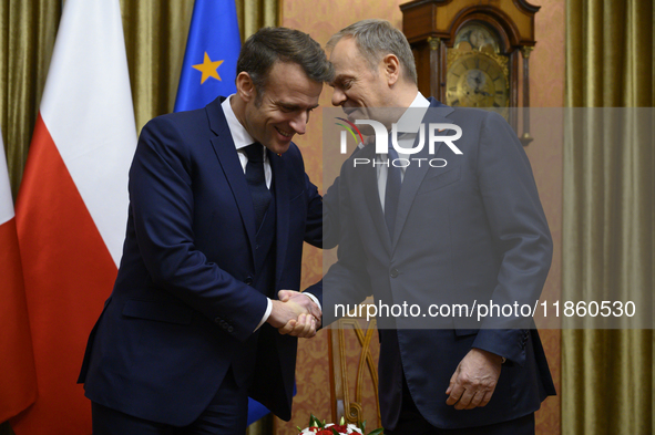 Polish Prime Minister Donald Tusk welcomes French President Emmanuel Macron in Warsaw, Poland, on December 11, 2024. 