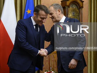 Polish Prime Minister Donald Tusk welcomes French President Emmanuel Macron in Warsaw, Poland, on December 11, 2024. (