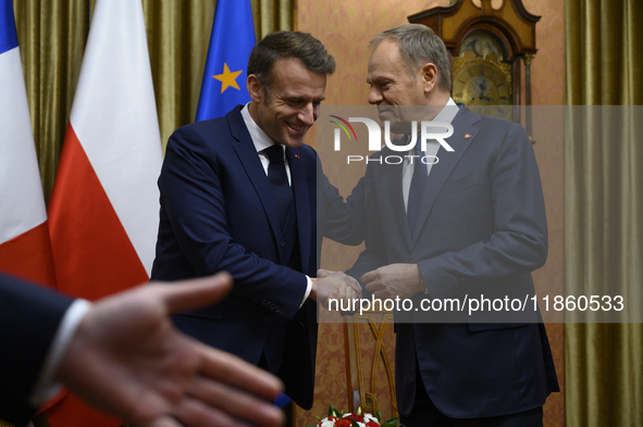 Polish Prime Minister Donald Tusk welcomes French President Emmanuel Macron in Warsaw, Poland, on December 11, 2024. 