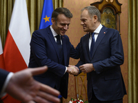 Polish Prime Minister Donald Tusk welcomes French President Emmanuel Macron in Warsaw, Poland, on December 11, 2024. (