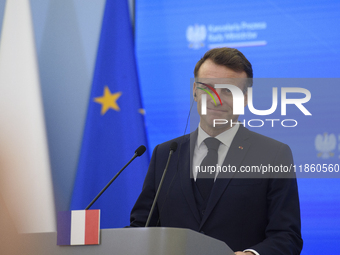 French President Emmanuel Macron looks on during a press conference with Polish Prime Minister Donald Tusk after talks in Warsaw, Poland, on...