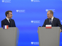 French President Emmanuel Macron and Polish Prime Minister Donald Tusk hold a press conference after talks in Warsaw, Poland, on December 12...