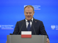 Polish Prime Minister Donald Tusk looks down as he speaks during a press conference with French President Emmanuel Macron after talks in War...