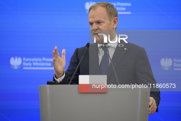 Polish Prime Minister Donald Tusk gestures as he speaks during a press conference with French President Emmanuel Macron after talks in Warsa...