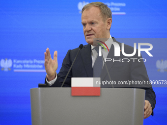 Polish Prime Minister Donald Tusk gestures as he speaks during a press conference with French President Emmanuel Macron after talks in Warsa...