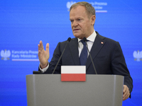 Polish Prime Minister Donald Tusk gestures as he speaks during a press conference with French President Emmanuel Macron after talks in Warsa...