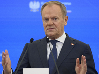 Polish Prime Minister Donald Tusk gestures as he speaks during a press conference with French President Emmanuel Macron after talks in Warsa...